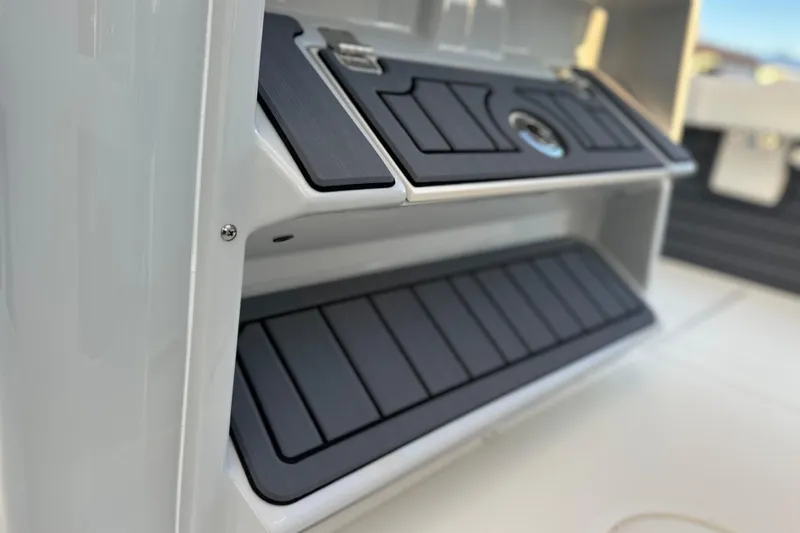 Slide: The Image of 2026 Pathfinder 2600 TRS boat storage compartment with sleek black panels. - 14