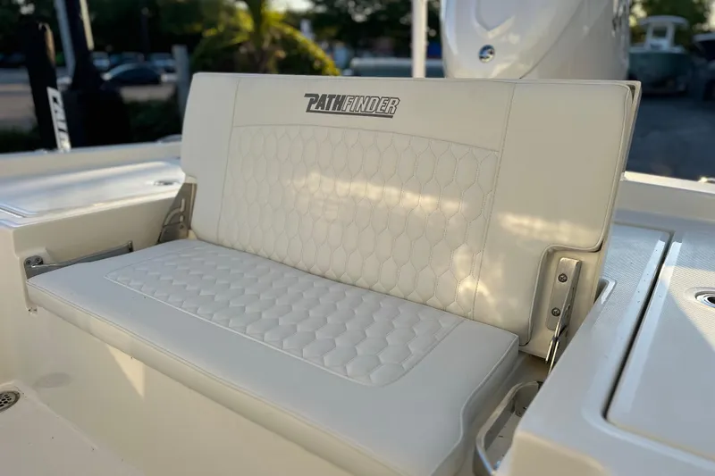 Slide: The Image of 2026 Pathfinder 2600 TRS boat seat with quilted white upholstery in sunlight. - 18
