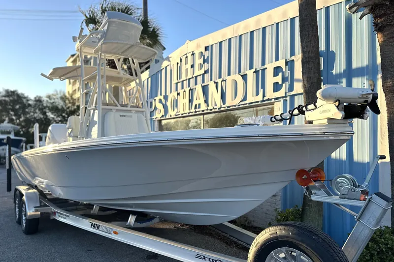 Slide: The Image of 2026 Pathfinder 2600 TRS boat on trailer outside marine supply store. - 19