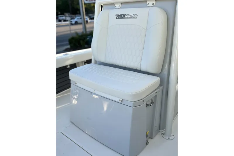 Slide: The Image of 2026 Pathfinder 2600 TRS boat seat with white cushioned backrest and storage compartment. - 2