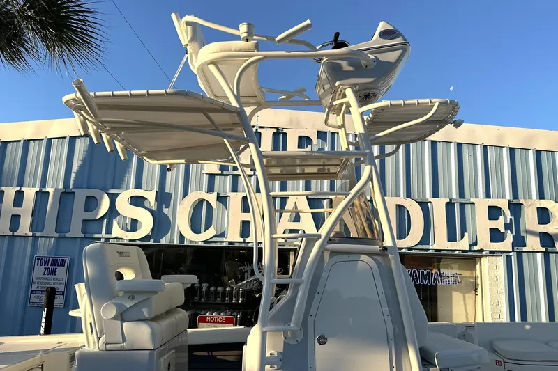 Slide: The Image of 2026 Pathfinder 2600 TRS boat with elevated helm, displayed outside a marine store. - 22