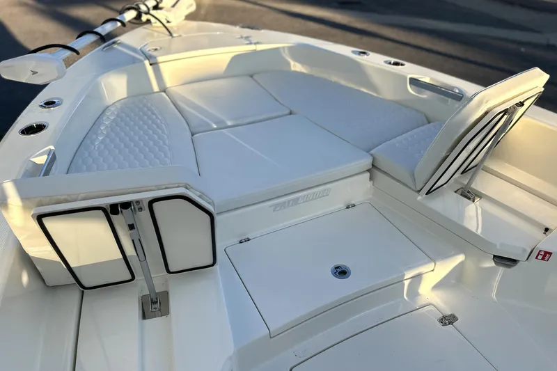 Slide: The Image of 2026 Pathfinder 2600 TRS boat interior with white cushioned seating and storage compartments. - 3