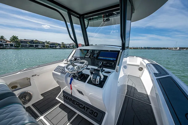 Slide: The Image of Helm of 2025 Hammer Yachts 30, featuring modern controls and scenic waterfront view. - 18