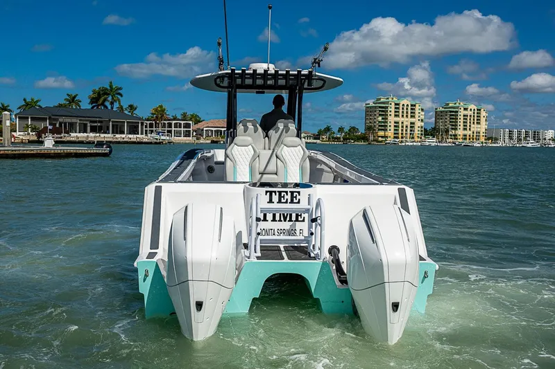 Slide: The Image of 2025 Hammer Yachts 30 cruising in sunny waters near coastal buildings. - 2