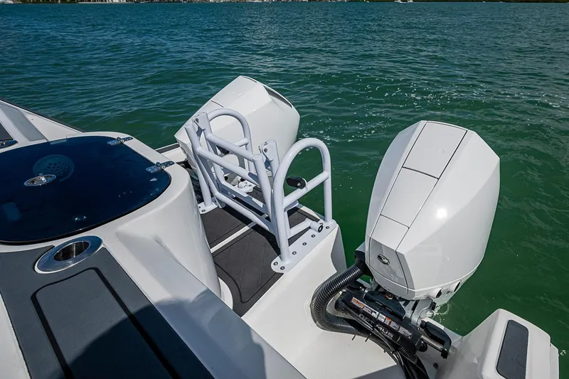 Slide: The Image of 2025 Hammer Yachts 30 with dual outboard motors on calm water. - 22