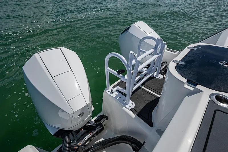 Slide: The Image of 2025 Hammer Yachts 30 with dual outboard motors on calm water. - 23