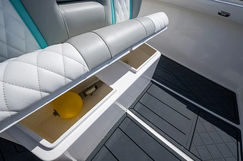 Slide: The Image of Storage compartments on a 2025 Hammer Yachts 30, featuring quilted seating and a yellow buoy. - 26