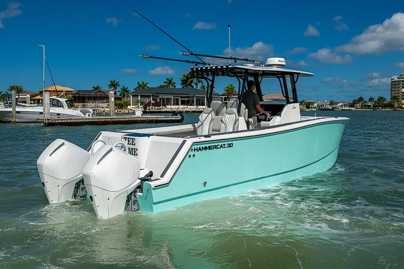 Slide: The Image of 2025 Hammer Yachts 30 catamaran cruising in sunny marina waters. - 3