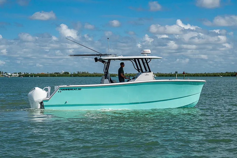 Slide: The Image of 2025 Hammer Yachts 30 boat cruising on a sunny day in calm waters. - 5