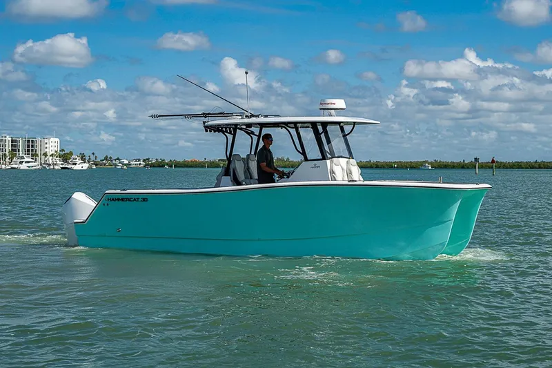Slide: The Image of 2025 Hammer Yachts 30 cruising on a sunny day with clear skies and calm waters. - 6