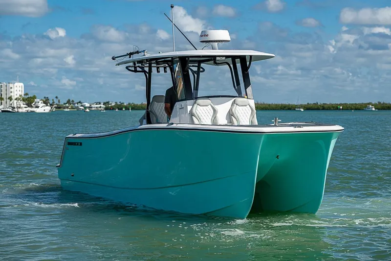 Slide: The Image of 2025 Hammer Yachts 30 catamaran cruising on a sunny day with clear skies. - 7