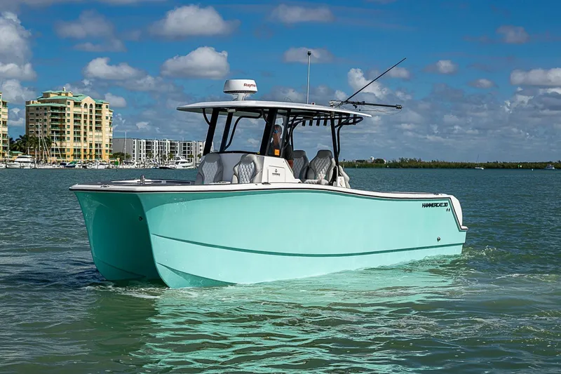 Slide: The Image of 2025 Hammer Yachts 30 catamaran cruising in sunny coastal waters. - 9