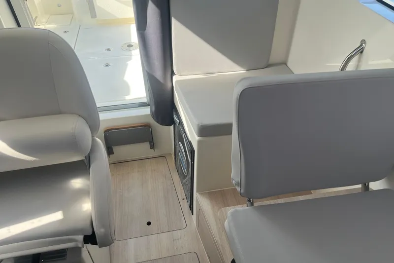 Slide: The Image of Interior of 2025 Bayliner Trophy T25 Pilothouse with modern seating and sleek design. - 10