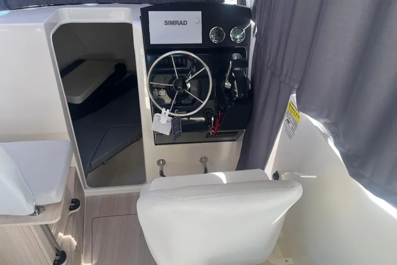 Slide: The Image of Interior view of 2025 Bayliner Trophy T25 Pilothouse with steering wheel and cabin. - 13