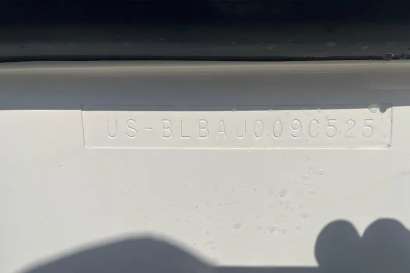Slide: The Image of 2025 Bayliner Trophy T25 Pilothouse hull identification number (HIN) embossed on white surface. - 7