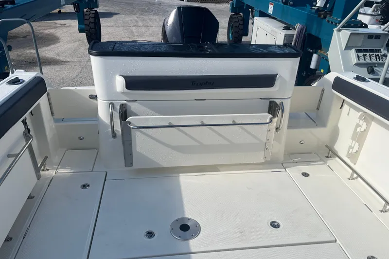 Slide: The Image of 2025 Bayliner Trophy T25 Pilothouse boat deck with seating and storage compartments. - 9