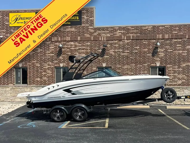 The Image of Chaparral 21 SSi 2026 on a trailer in front of a brick building. Special offers advertised. - 1