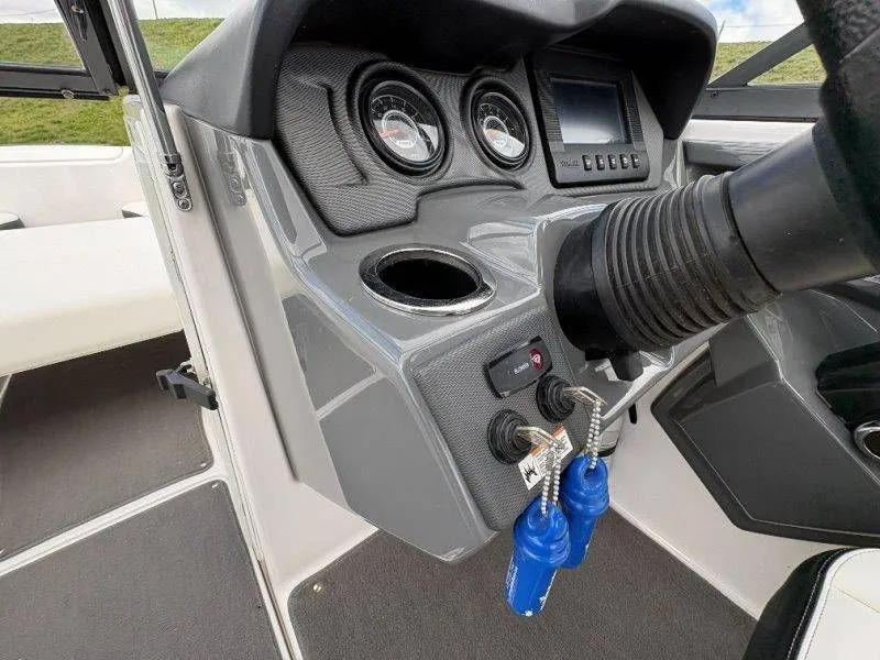 Slide: The Image of Dashboard of a 2016 Yamaha AR240 boat with keys and instruments. - 46