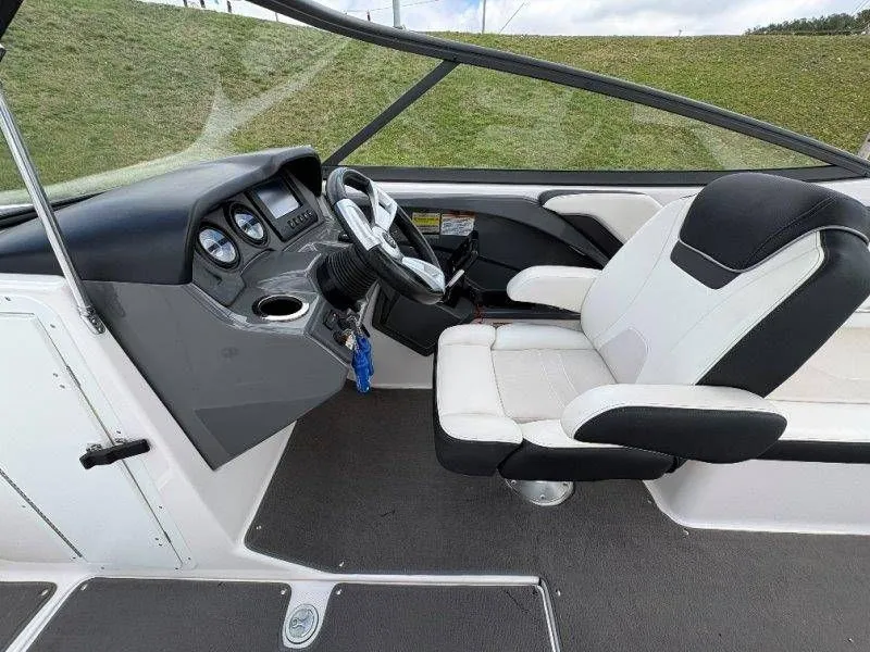 Slide: The Image of Interior of a 2016 Yamaha AR240 boat with steering console. - 48