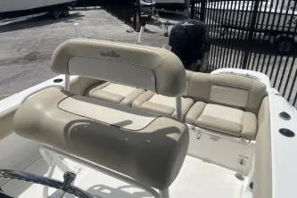 Slide: The Image of 2023 NauticStar 2302 Legacy boat interior with beige seating and sleek design. - 11