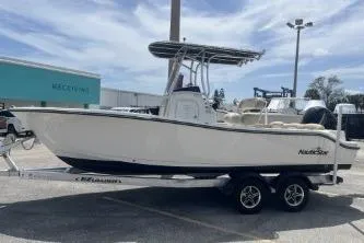 Slide: The Image of 2023 NauticStar 2302 Legacy boat on trailer in parking lot. - 5