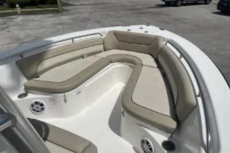 Slide: The Image of 2023 NauticStar 2302 Legacy boat with spacious beige seating and built-in speakers. - 9