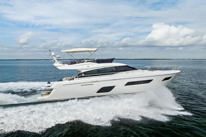 Slide: The Image of 2018 Ferretti Yachts 550 cruising on open water under a cloudy sky. - 15