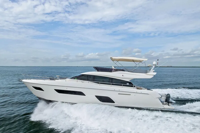 Slide: The Image of 2018 Ferretti Yachts 550 cruising on open water under a clear sky. - 21
