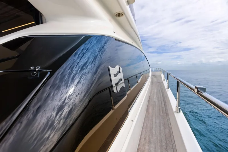 Slide: The Image of Side view of a 2018 Ferretti Yachts 550, reflecting ocean and sky. - 39