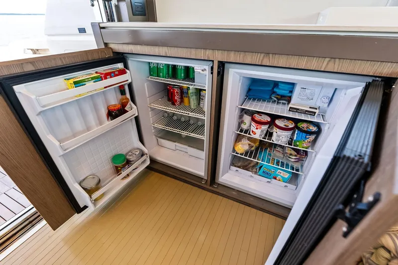 Slide: The Image of Open fridge and freezer on 2018 Ferretti Yachts 550, stocked with drinks and food. - 51
