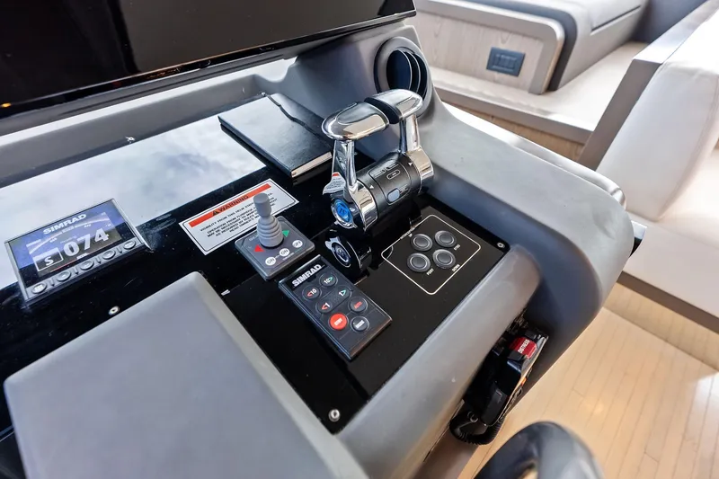 Slide: The Image of Control panel of a 2018 Ferretti Yachts 550, featuring Simrad navigation equipment. - 60