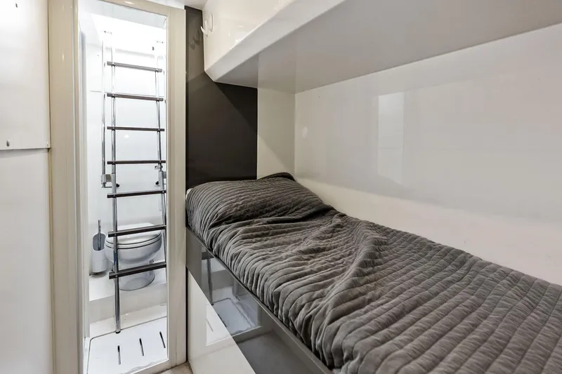 Slide: The Image of Compact cabin interior of 2018 Ferretti Yachts 550 with bed and ladder-accessed bathroom. - 66