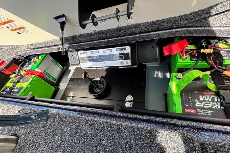 Slide: The Image of 2025 Ranger Z520R boat battery compartment with lithium batteries and charging system. - 14