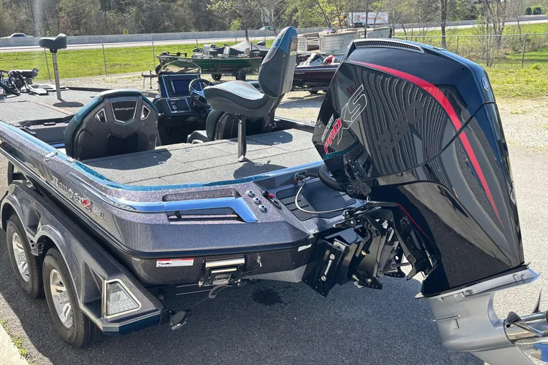 Slide: The Image of 2025 Ranger Z520R boat with powerful outboard motor, parked on a sunny day. - 16