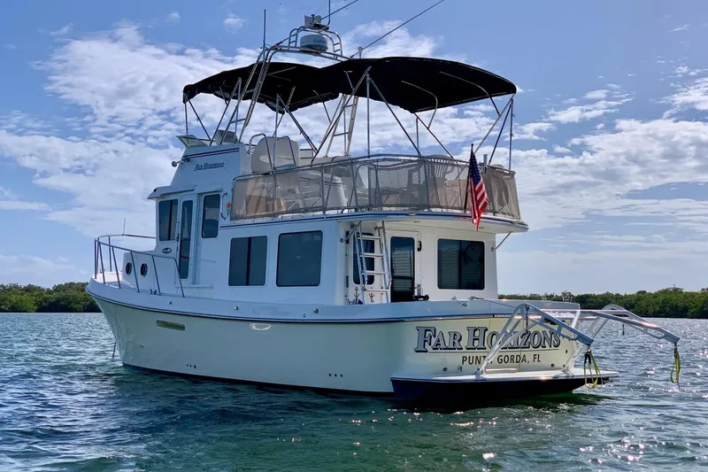 Slide: The Image of 2009 American Tug 34 Rare Flybridge Model on water, displaying "Far Horizons" name. - 100