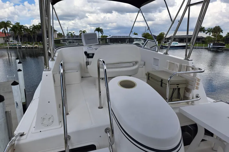 Slide: The Image of 2009 American Tug 34 Rare Flybridge Model with sleek design, docked by a scenic waterfront. - 11