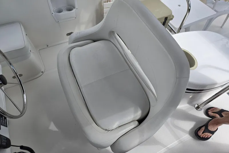 Slide: The Image of Captain's seat on 2009 American Tug 34 Rare Flybridge Model, featuring white upholstery. - 13