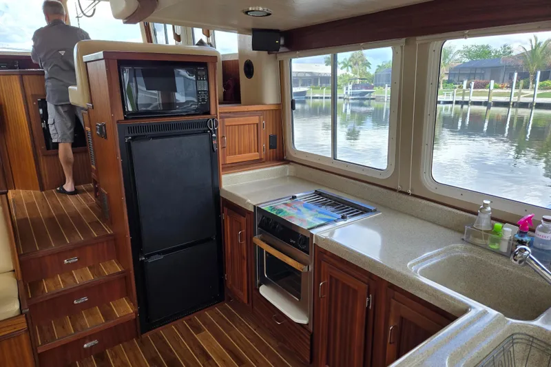 Slide: The Image of Interior of 2009 American Tug 34 Rare Flybridge Model with kitchen and waterfront view. - 21