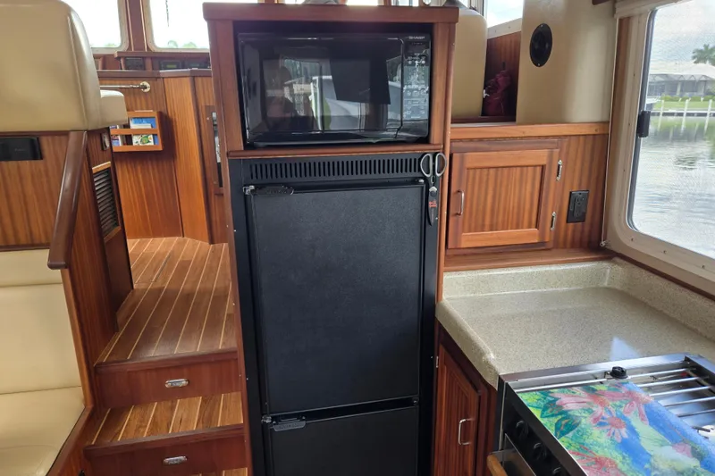 Slide: The Image of Interior of 2009 American Tug 34 Rare Flybridge Model with kitchen amenities. - 24