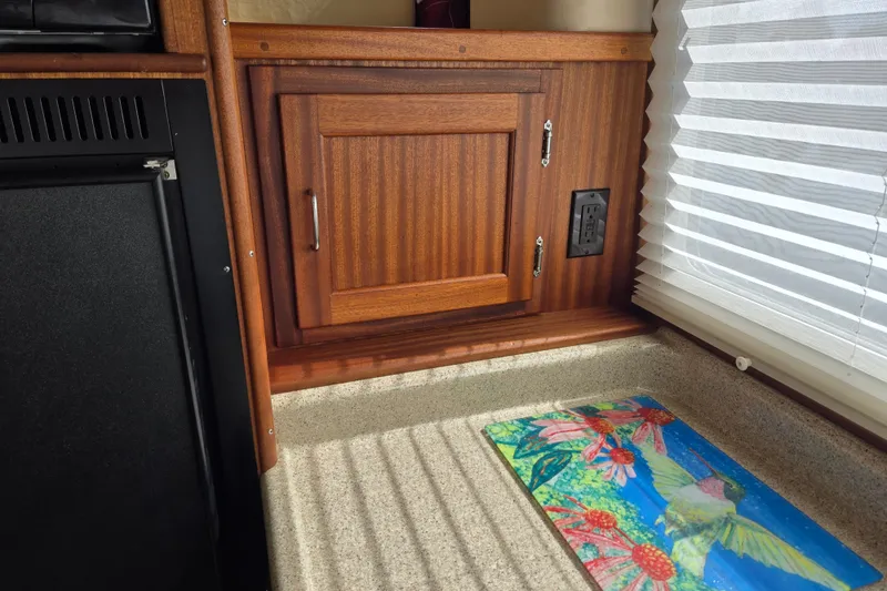 Slide: The Image of Interior of 2009 American Tug 34 Rare Flybridge Model with wooden cabinet and colorful mat. - 26