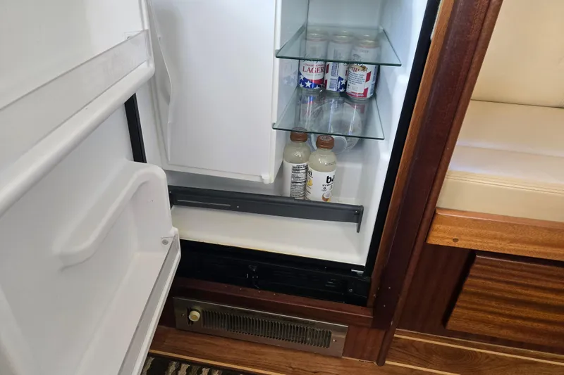 Slide: The Image of Open fridge in 2009 American Tug 34 Rare Flybridge Model, stocked with beverages. - 28