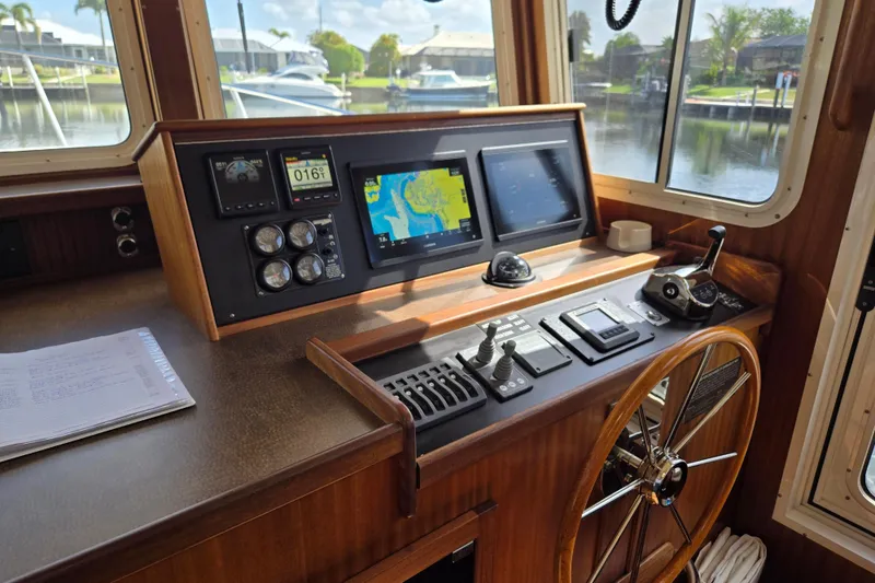 Slide: The Image of 2009 American Tug 34 Rare Flybridge Model helm with navigation instruments and wooden steering wheel. - 31
