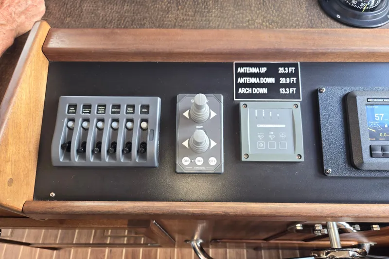 Slide: The Image of Control panel of a 2009 American Tug 34 Rare Flybridge Model with various switches and displays. - 33