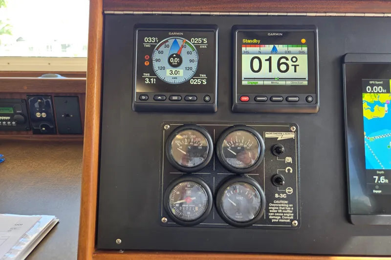 Slide: The Image of American Tug 34 Rare Flybridge Model 2009 dashboard with Garmin navigation instruments. - 34