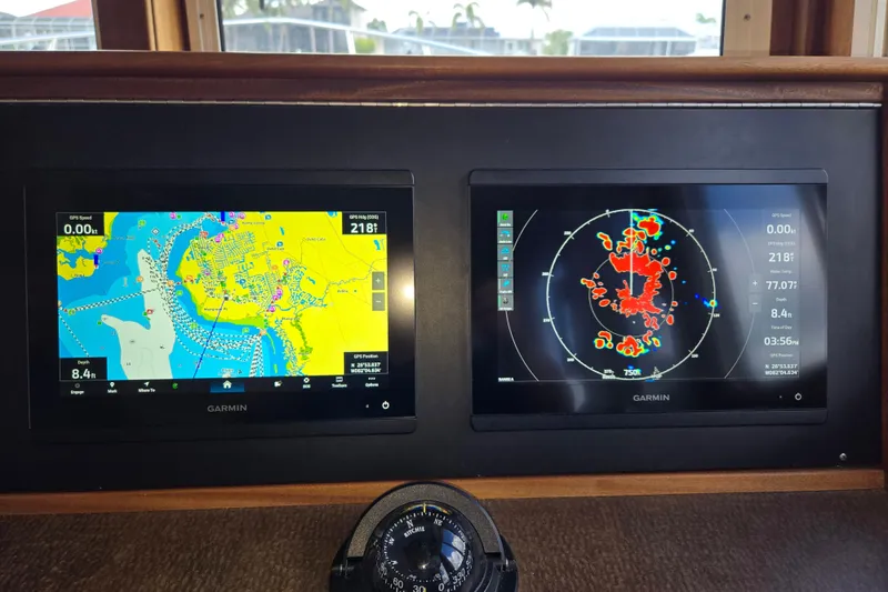 Slide: The Image of Garmin navigation displays on 2009 American Tug 34 Rare Flybridge Model, showcasing maps and radar. - 35