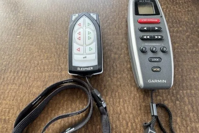 Slide: The Image of Remote controls for Sleipner and Garmin devices on a wooden surface, related to American Tug 34. - 38