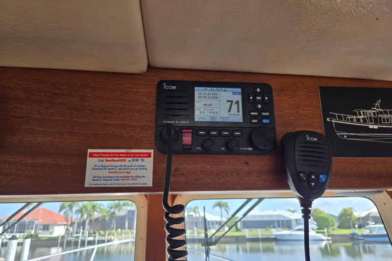 Slide: The Image of VHF marine radio on 2009 American Tug 34 Rare Flybridge Model, docked near waterfront homes. - 40