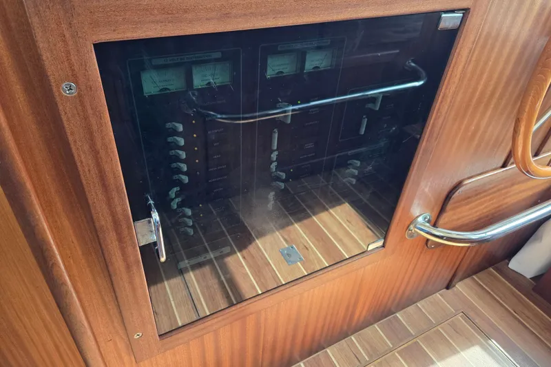 Slide: The Image of Electrical panel inside 2009 American Tug 34 Rare Flybridge Model, featuring wooden cabinetry. - 43