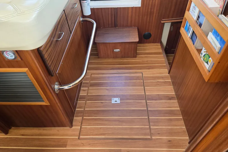 Slide: The Image of 2009 American Tug 34 Rare Flybridge Model interior with wooden flooring and storage compartments. - 45
