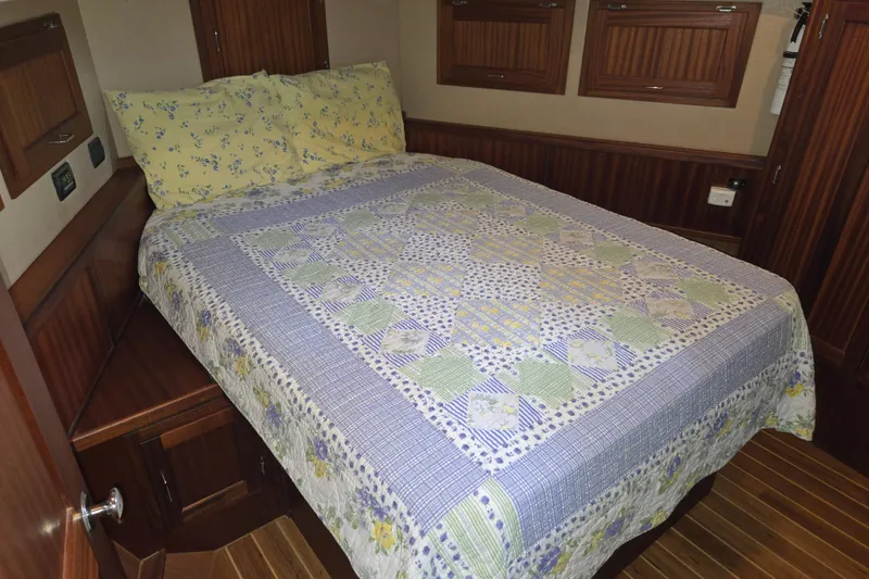 Slide: The Image of Cozy bedroom in 2009 American Tug 34 Rare Flybridge Model with floral quilt and wooden accents. - 47